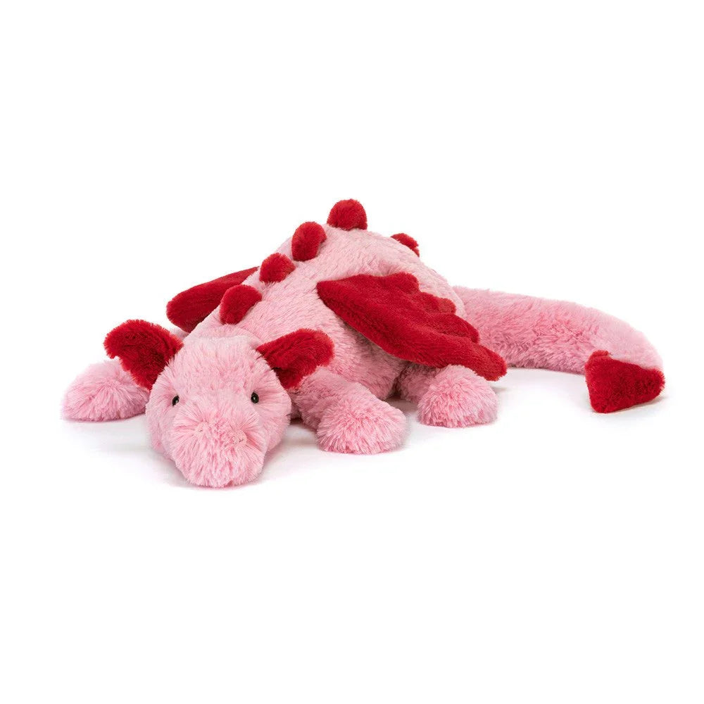 Myk rosa plysdrage med røde vinger og stikker, perfekt barneleketøy for små barn