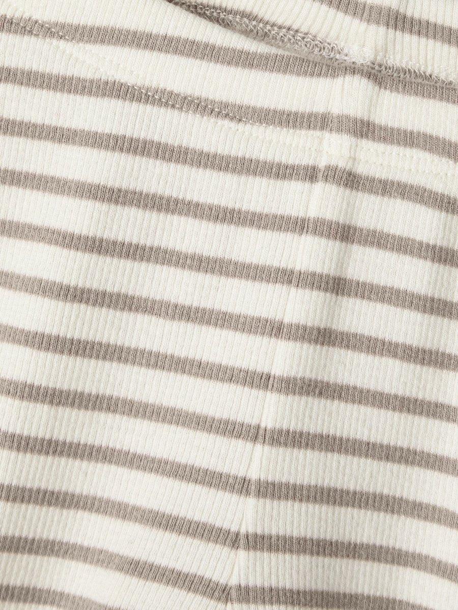 Myk strikket barneklær med horisontale striper i beige og hvit, bærekraftig tekstil for spedbarn og småbarn.