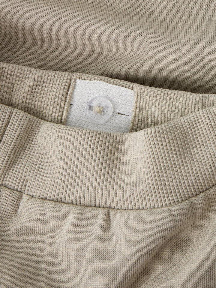 Beige barnebukse med knapp og ribbet liv, myk tekstil for spedbarn og småbarn