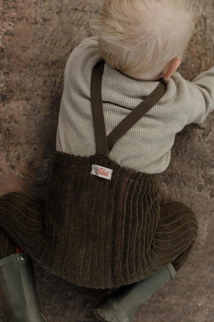 Barn i myke ullbukser og genser, perfekt barneklær for 0-8 år med bærekraftig design.