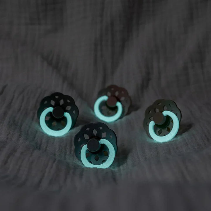 Glow-in-the-dark baby rattles with lace design on soft fabric, ideal for newborns and infants