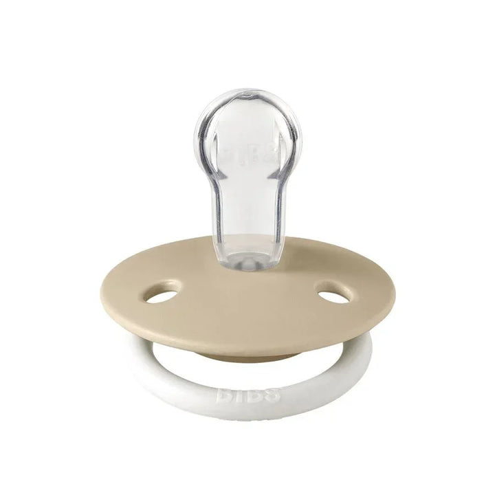 Beige DIBS babysove med gjennomsiktig nippel og hvit ring, myk og trygg for spedbarn
